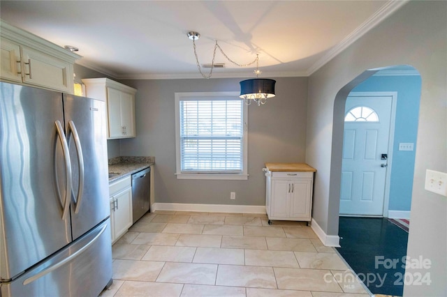 kitchen featuring stone counters, appliances with stainless steel finishes, decorative light fixtures, and crown molding