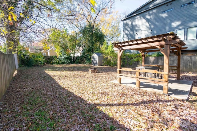 view of yard with a pergola and a shed