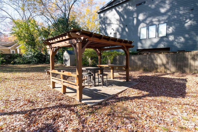 view of home's community featuring a pergola, a patio, and a storage unit