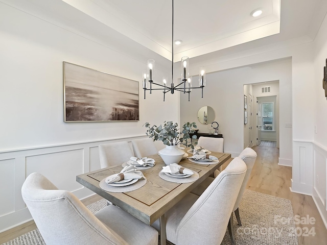 dining room featuring an inviting chandelier and light hardwood / wood-style flooring