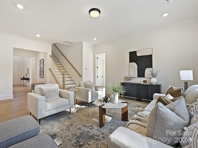 living room with crown molding and hardwood / wood-style flooring