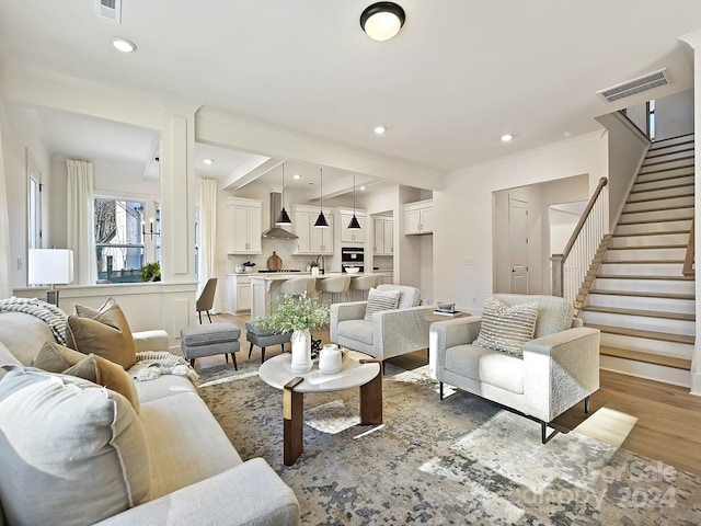 living room with light hardwood / wood-style floors and sink