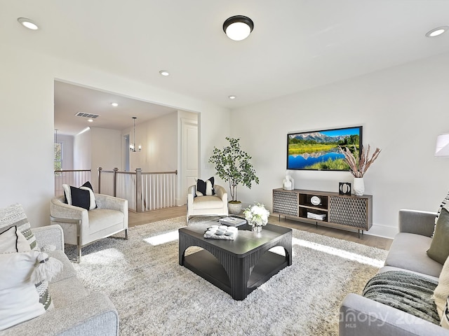 living room featuring light hardwood / wood-style flooring and a chandelier