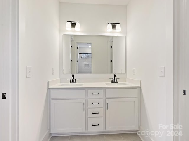 bathroom with tile patterned floors and vanity