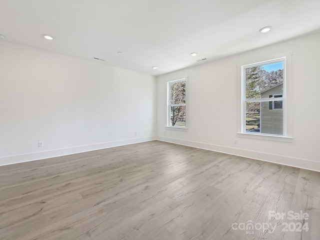 spare room featuring light hardwood / wood-style flooring