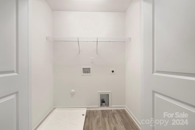 clothes washing area with hardwood / wood-style flooring, washer hookup, hookup for a gas dryer, and hookup for an electric dryer