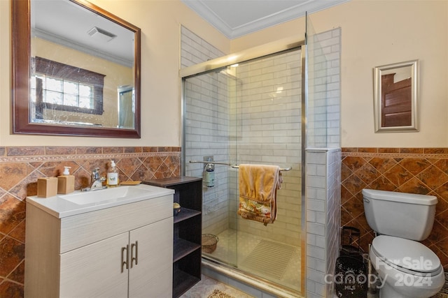 bathroom featuring toilet, tile walls, crown molding, and a shower with shower door