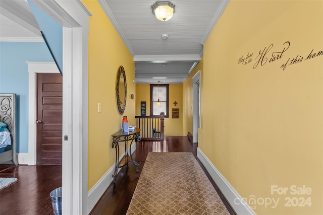 corridor with ornamental molding and dark wood-type flooring