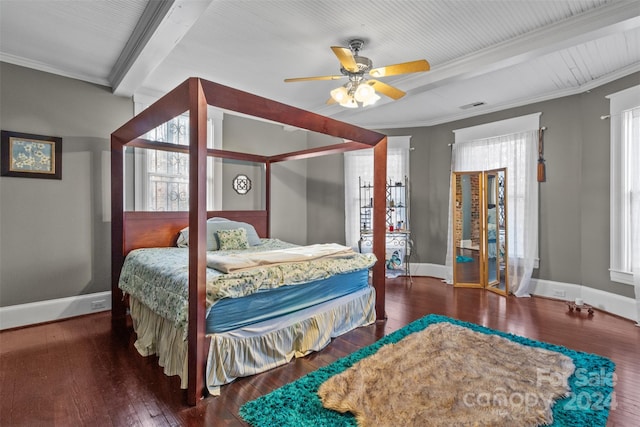 bedroom with multiple windows, dark hardwood / wood-style floors, ceiling fan, and beamed ceiling