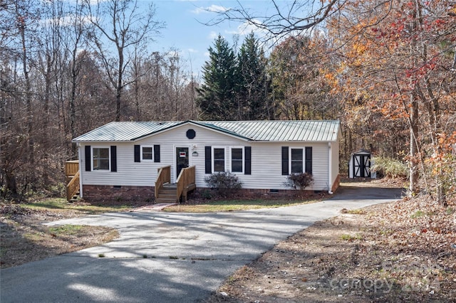 single story home with a storage shed