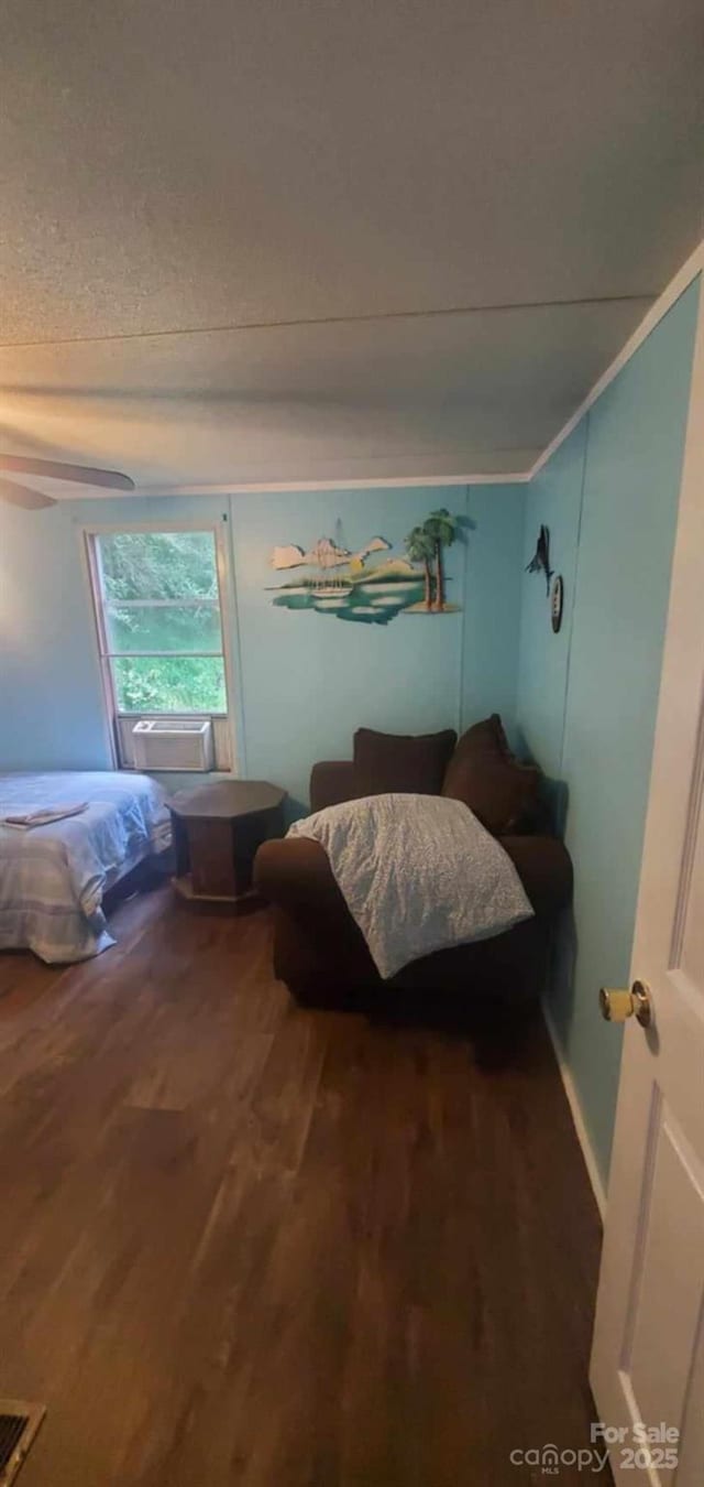 bedroom with visible vents, ornamental molding, and wood finished floors