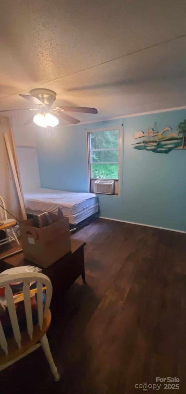 bedroom with ceiling fan, cooling unit, and wood finished floors