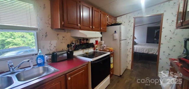 kitchen featuring wallpapered walls, under cabinet range hood, brown cabinets, white appliances, and a sink