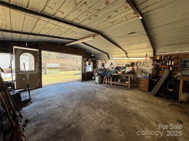 garage featuring a workshop area and metal wall