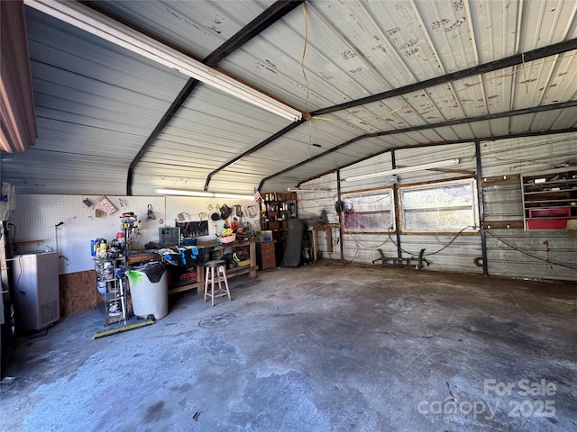 garage with a workshop area and metal wall