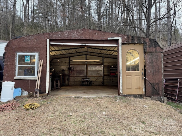 view of outdoor structure with an outbuilding, driveway, and a garage