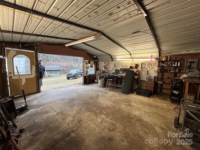 garage featuring a workshop area and metal wall