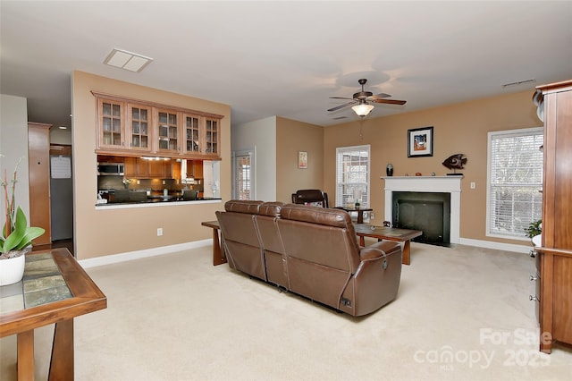 living room featuring ceiling fan and light carpet