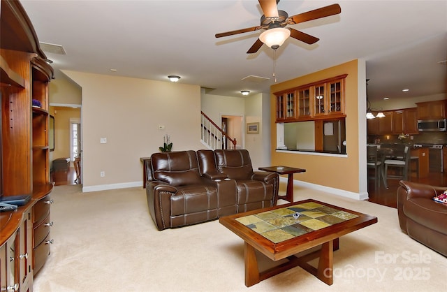 carpeted living room with ceiling fan