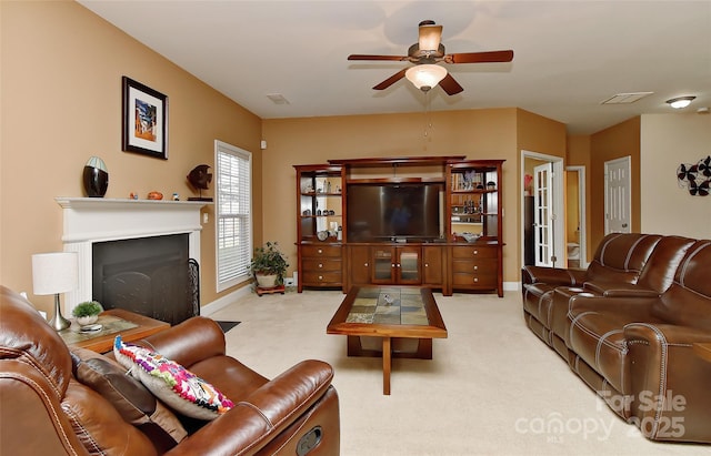 living room with ceiling fan and light colored carpet