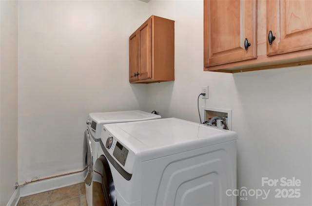 laundry area featuring cabinets and washing machine and clothes dryer