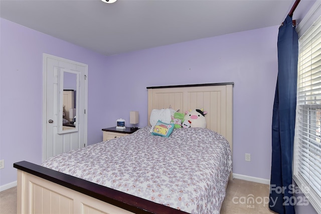 bedroom featuring light carpet