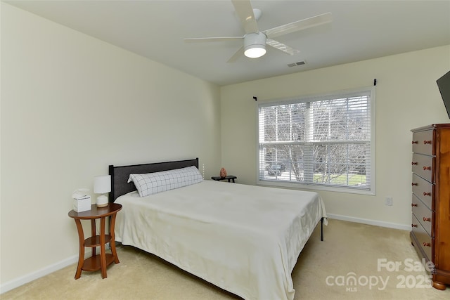 bedroom featuring light colored carpet and ceiling fan