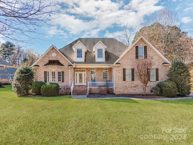 view of front of home with covered porch and a front yard