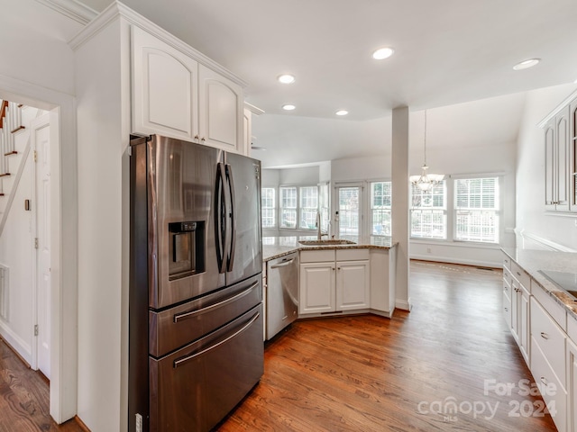 kitchen featuring white cabinets, light hardwood / wood-style floors, lofted ceiling, and appliances with stainless steel finishes