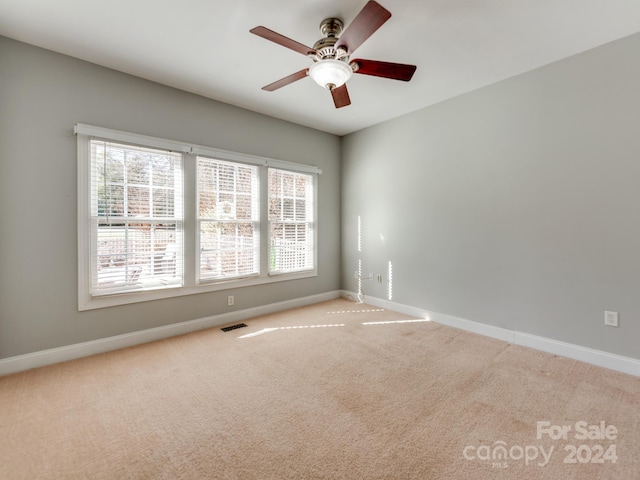 empty room with light carpet and ceiling fan