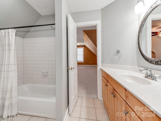 bathroom with tile patterned floors, lofted ceiling, a textured ceiling, shower / bath combo with shower curtain, and vanity