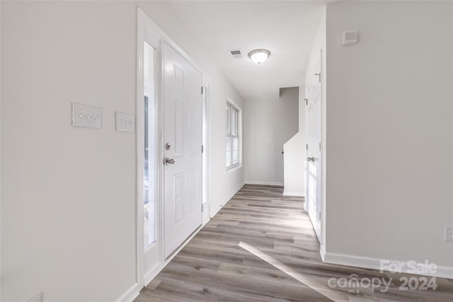 hall with light hardwood / wood-style flooring