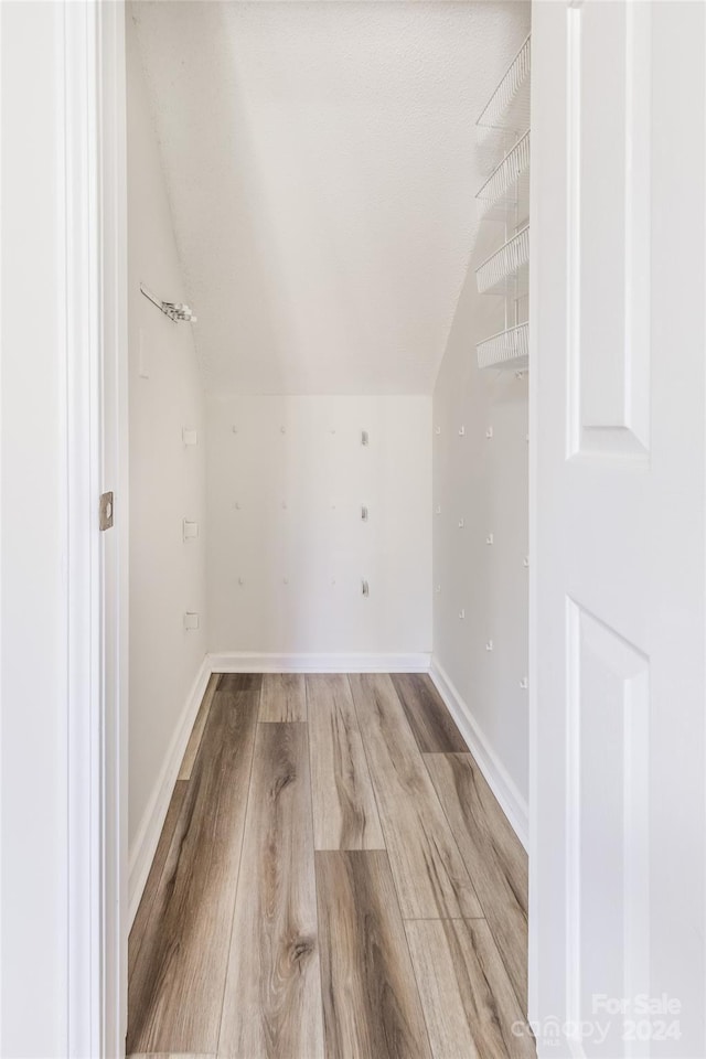 bonus room featuring light hardwood / wood-style floors and lofted ceiling