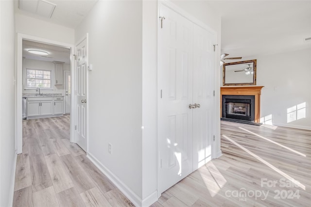 hall featuring sink and light wood-type flooring