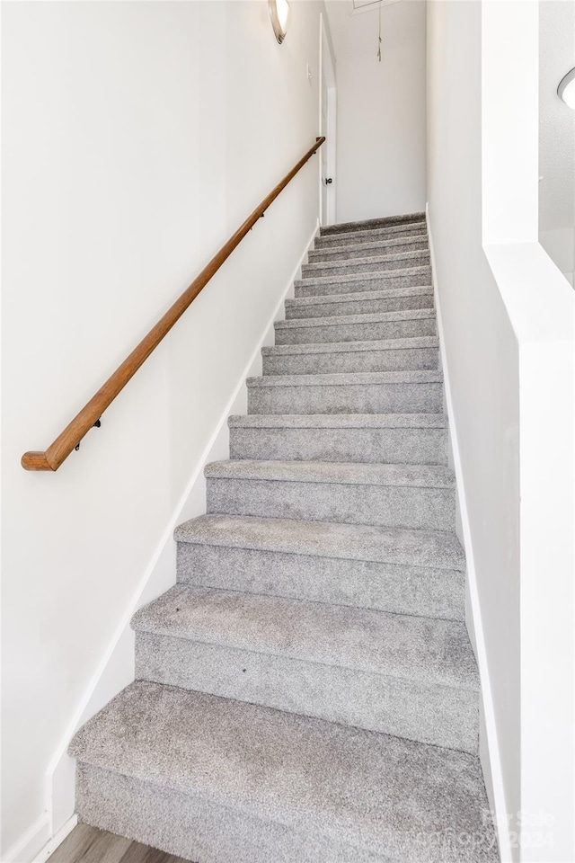 staircase featuring hardwood / wood-style floors