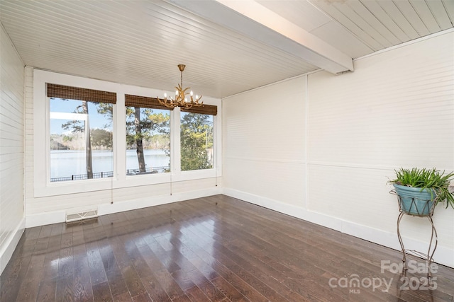 unfurnished dining area featuring a chandelier, a water view, dark hardwood / wood-style floors, and beamed ceiling