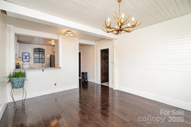 interior space with dark hardwood / wood-style flooring and a chandelier