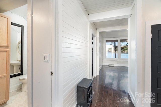 hallway with hardwood / wood-style floors and beamed ceiling