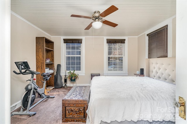 bedroom featuring ceiling fan, ornamental molding, and carpet floors