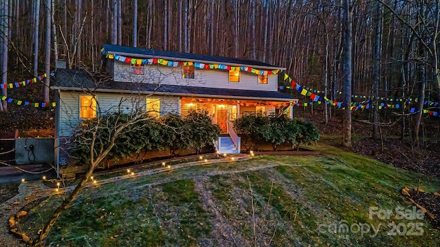 rear view of property featuring a yard