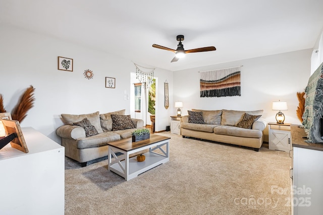 living room with ceiling fan and carpet