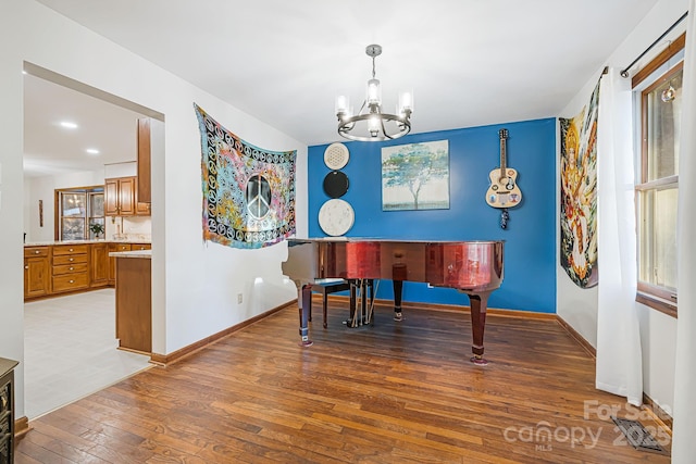 misc room featuring a notable chandelier, a healthy amount of sunlight, and hardwood / wood-style floors