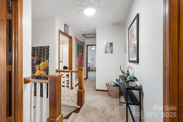 corridor featuring light colored carpet