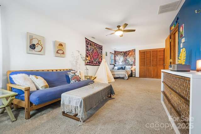 carpeted living room with ceiling fan