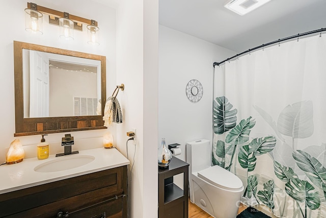 bathroom with toilet and vanity