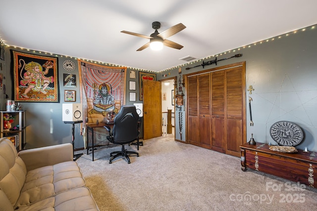 office with ceiling fan and light carpet