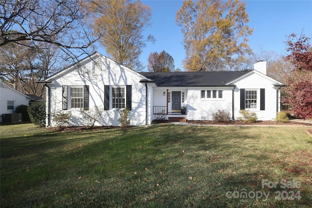 single story home featuring central AC unit and a front lawn