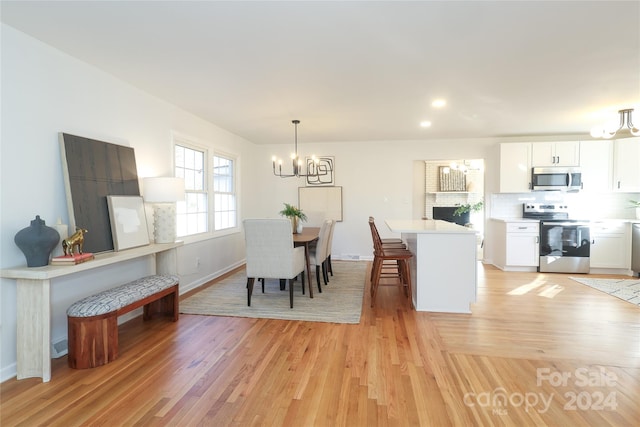 dining room featuring a chandelier and light wood-type flooring