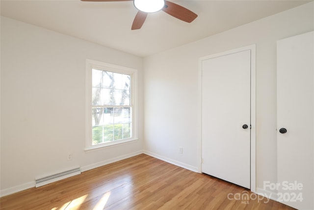 unfurnished bedroom with ceiling fan and light hardwood / wood-style flooring