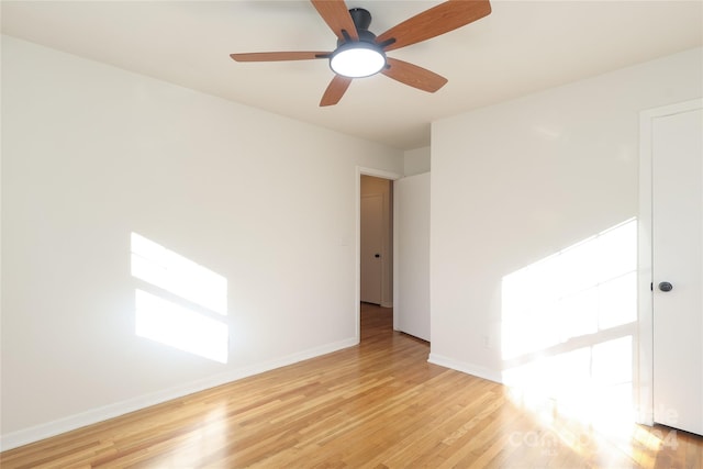 empty room featuring ceiling fan and light hardwood / wood-style floors